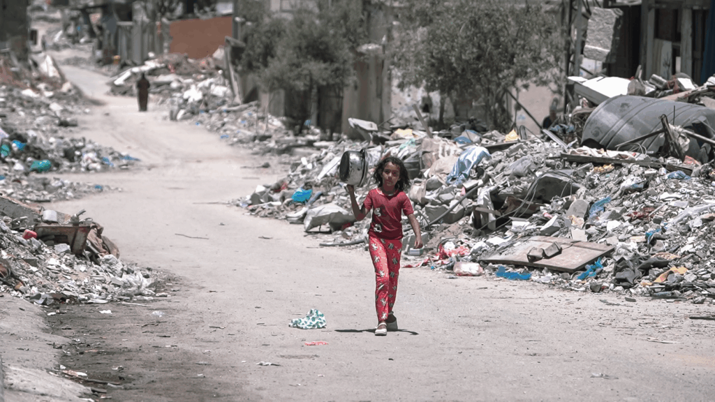A girl walks inside Gaza during the Gaza-Israel war to get food