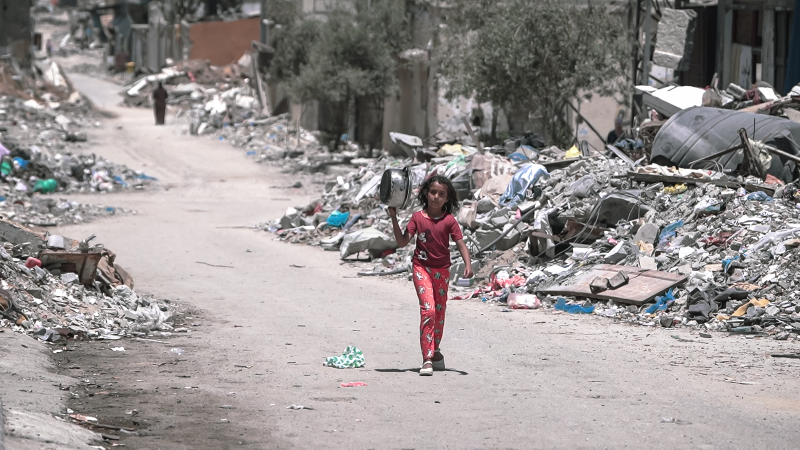 A girl walks inside Gaza during the Gaza-Israel war to get food